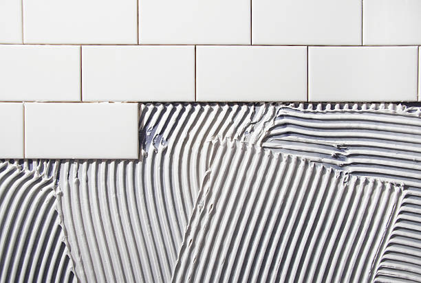 Tile placed over mastic in home renovation.